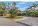 Charming home showcasing a circular driveway, lush landscaping, and mature trees at 4301 S Lockwood Ridge Rd, Sarasota, FL 34231