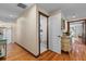 Hallway showcasing hardwood flooring, an updated half bath, and access to the main living spaces at 4301 S Lockwood Ridge Rd, Sarasota, FL 34231