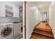 Hallway with gleaming wood floors leading to a laundry area with white appliances at 4301 S Lockwood Ridge Rd, Sarasota, FL 34231