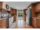 Kitchen with wood cabinets, stainless steel appliances, and sliding glass doors to the backyard at 4301 S Lockwood Ridge Rd, Sarasota, FL 34231