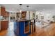 Open-concept kitchen with blue island, wine cooler, and bar seating flowing into the living area at 4301 S Lockwood Ridge Rd, Sarasota, FL 34231