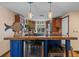 Kitchen island with bar seating and wine fridge, complementing the adjacent fully-equipped kitchen at 4301 S Lockwood Ridge Rd, Sarasota, FL 34231