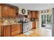 Kitchen with wood cabinetry, granite countertops, and modern appliances at 4301 S Lockwood Ridge Rd, Sarasota, FL 34231