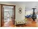 Inviting living room with hardwood floors, decor and a peek into the well-lit primary bedroom at 4301 S Lockwood Ridge Rd, Sarasota, FL 34231