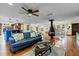 Spacious open-concept living room featuring hardwood floors, ceiling fan, and seamless transition to the kitchen at 4301 S Lockwood Ridge Rd, Sarasota, FL 34231