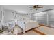 Bright main bedroom with large bed, neutral colored walls and floors and ceiling fan at 4301 S Lockwood Ridge Rd, Sarasota, FL 34231