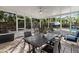 Covered patio with ceiling fan overlooking pool and lush landscaping at 4301 S Lockwood Ridge Rd, Sarasota, FL 34231