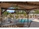 Outdoor covered bar area overlooking the pool with a waterfall feature, ideal for entertaining guests at 4301 S Lockwood Ridge Rd, Sarasota, FL 34231