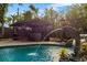 Outdoor pool with dolphin statue and covered bar area at 4301 S Lockwood Ridge Rd, Sarasota, FL 34231