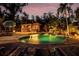 Backyard pool and tiki bar at dusk, creating a relaxing and inviting outdoor space at 4301 S Lockwood Ridge Rd, Sarasota, FL 34231