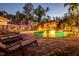 Inviting backyard pool with waterfall feature, poolside bar, and cozy lounge area, perfect for entertaining at 4301 S Lockwood Ridge Rd, Sarasota, FL 34231