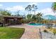 Backyard with pool, outdoor kitchen, and patio seating at 4301 S Lockwood Ridge Rd, Sarasota, FL 34231