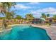 Inviting pool area with lounge chairs, dolphin statue, and outdoor seating, perfect for relaxing and entertaining at 4301 S Lockwood Ridge Rd, Sarasota, FL 34231