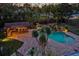 Backyard pool area featuring a bar, a waterfall feature, beautiful landscaping, and ample space for outdoor relaxation at 4301 S Lockwood Ridge Rd, Sarasota, FL 34231