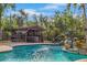 Backyard pool featuring a dolphin fountain and outdoor bar at 4301 S Lockwood Ridge Rd, Sarasota, FL 34231