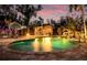 Backyard pool and tiki bar with water feature, offering a luxurious and relaxing outdoor space at 4301 S Lockwood Ridge Rd, Sarasota, FL 34231