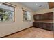 Spacious bonus room featuring tile flooring, two windows, and built in cabinetry for ample storage at 4301 S Lockwood Ridge Rd, Sarasota, FL 34231
