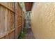Narrow side yard with a wooden fence and gate, showcasing access to the backyard and property at 4301 S Lockwood Ridge Rd, Sarasota, FL 34231