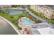 Aerial view showcasing the community pool, tennis courts, and lush landscaping at 4550 Cove Cir # 1003, St Petersburg, FL 33708