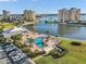 Aerial view highlighting the community pool, waterfront views, and meticulously maintained grounds at 4550 Cove Cir # 1003, St Petersburg, FL 33708