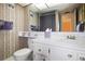 Bathroom with patterned walls, under-mounted sink, and decorative countertop accessories at 4550 Cove Cir # 1003, St Petersburg, FL 33708