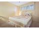 Well-lit bedroom with neutral carpet, shuttered windows, and comfortable patterned quilt at 4550 Cove Cir # 1003, St Petersburg, FL 33708