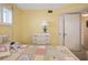 Bright bedroom with neutral carpet, shuttered windows, and cozy patterned quilt at 4550 Cove Cir # 1003, St Petersburg, FL 33708
