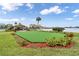 Community green space featuring a putting green, waterfront views, and outdoor picnic pavilion at 4550 Cove Cir # 1003, St Petersburg, FL 33708