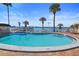 A pristine community pool offers lounge chairs and a view of the ocean, complete with a nearby pier at 4550 Cove Cir # 1003, St Petersburg, FL 33708