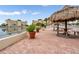 Charming poolside patio with tiki huts, picnic tables, and scenic waterfront views at 4550 Cove Cir # 1003, St Petersburg, FL 33708