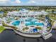 Aerial view of community center with pools, cabanas, and lush landscaping at 4620 Ballast Crest Cv, Land O Lakes, FL 34638