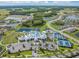 Aerial view of community with clubhouse, pools, tennis courts, and waterways at 4620 Ballast Crest Cv, Land O Lakes, FL 34638