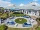 Aerial view of outdoor patio and seating with blue cushions surrounding a fire pit at 4620 Ballast Crest Cv, Land O Lakes, FL 34638