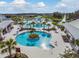 Aerial view of community pool with gazebo, palm trees, and surrounding lounge chairs at 4620 Ballast Crest Cv, Land O Lakes, FL 34638