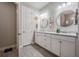 Bathroom featuring a double sink vanity, tile floors, framed mirrors, and modern fixtures at 4620 Ballast Crest Cv, Land O Lakes, FL 34638