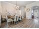 Stylish dining area with modern light fixtures, table, and hardwood flooring at 4620 Ballast Crest Cv, Land O Lakes, FL 34638
