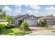 Beautiful single-story home with manicured lawn and brick driveway, exuding curb appeal at 4620 Ballast Crest Cv, Land O Lakes, FL 34638