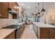 Spacious kitchen featuring wood cabinets, modern appliances, and seamless flow to the living area at 4620 Ballast Crest Cv, Land O Lakes, FL 34638