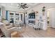Spacious living room with built-in shelving, fireplace, large windows, ceiling fan and modern furnishings at 4620 Ballast Crest Cv, Land O Lakes, FL 34638