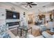 Open concept living room and kitchen featuring hardwood floors, recessed lighting, ceiling fan and modern furnishings at 4620 Ballast Crest Cv, Land O Lakes, FL 34638