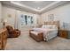 Bright bedroom featuring carpet floors, recessed lighting, a wicker bed frame, and modern furnishings at 4620 Ballast Crest Cv, Land O Lakes, FL 34638