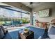 Comfortable screened patio with dining and seating areas and ceiling fan at 4620 Ballast Crest Cv, Land O Lakes, FL 34638
