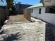 Paved backyard with a small patch of grass in a fenced in area at 5008 N Suwanee Ave, Tampa, FL 33603