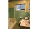 Bathroom featuring green tile and a shower at 5008 N Suwanee Ave, Tampa, FL 33603