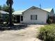 Charming single-story home with a green roof and a well-maintained lawn at 5008 N Suwanee Ave, Tampa, FL 33603