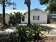 Charming one-story home featuring a lush front yard with beautiful tropical landscaping at 5008 N Suwanee Ave, Tampa, FL 33603