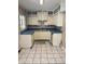 Compact kitchen with vintage cabinets and tile flooring at 5008 N Suwanee Ave, Tampa, FL 33603