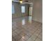 Bright living room featuring tile flooring, natural light and a ceiling fan at 5008 N Suwanee Ave, Tampa, FL 33603