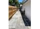 Narrow paved area with wooden fence and the side of the house at 5008 N Suwanee Ave, Tampa, FL 33603
