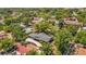 An aerial view of the home showing mature landscaping and a long driveway on a quiet, tree-lined street at 504 7Th Sw Ave, Largo, FL 33770